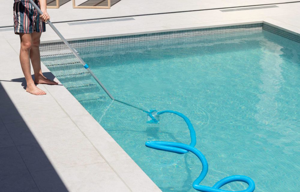 a man cleaning pool